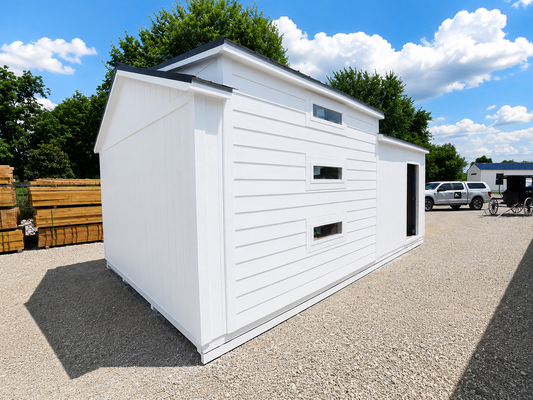 White Tiny Home and Swing shed with a black roof in an outdoor setting