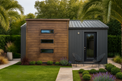 Modern shed with wooden exterior and glass door in a garden setting
